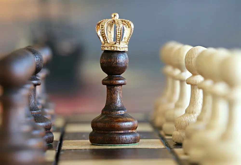 chess piece with a crown on a chess board